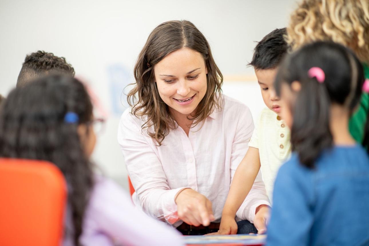 Child focused on reading exercises with a therapist