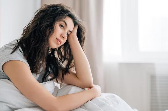 Person sitting alone experiencing low mood