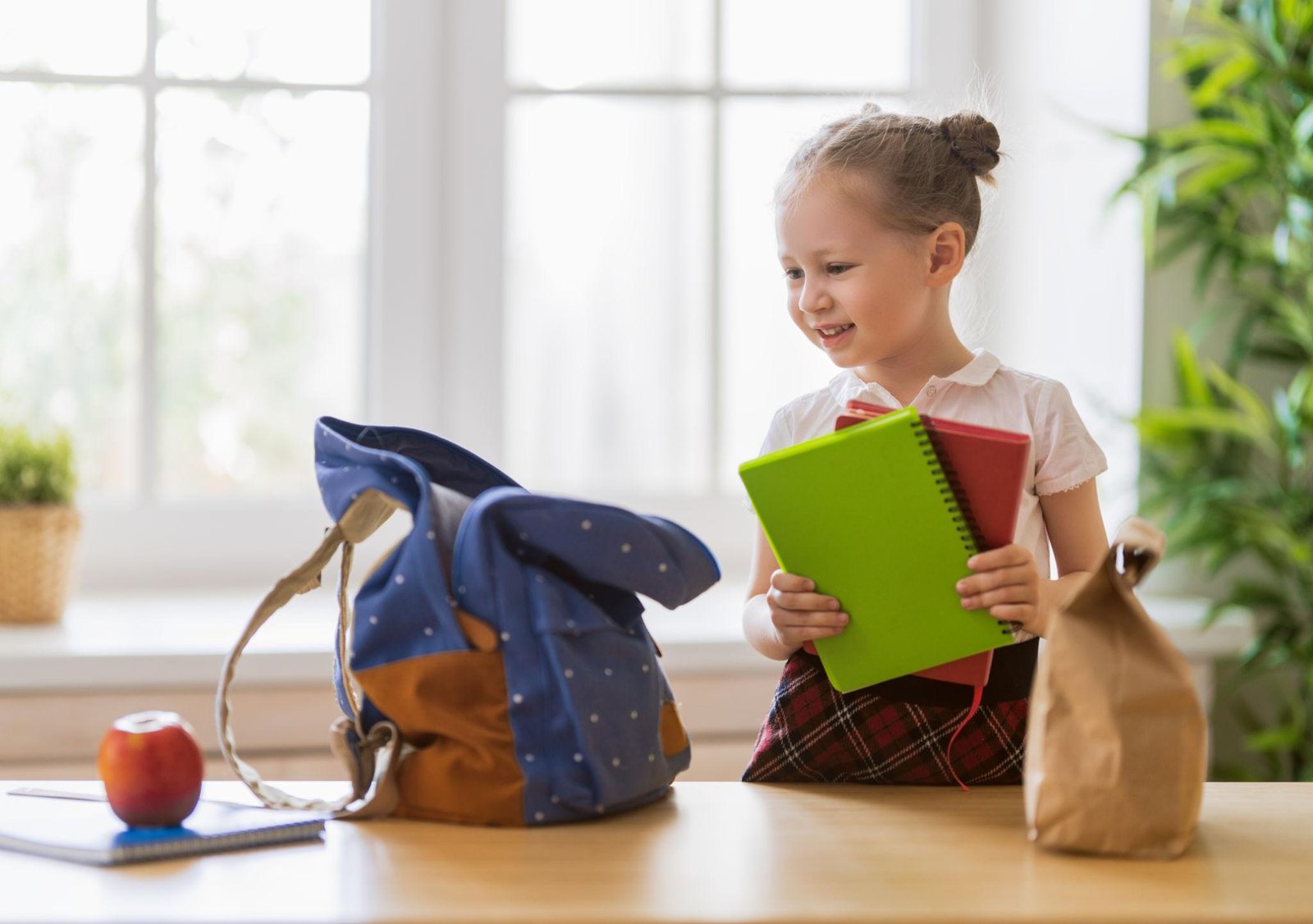 Child looking at school books for academic readiness in Dubai